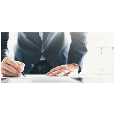 Businessperson signing a document